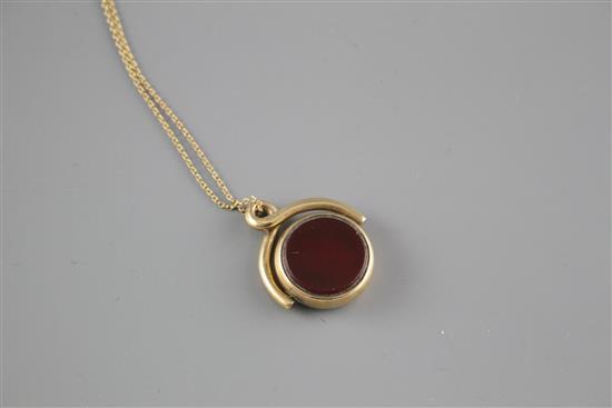 A late Victorian 9ct, bloodstone and carnelian set spinning fob, on an associated yellow metal chain,